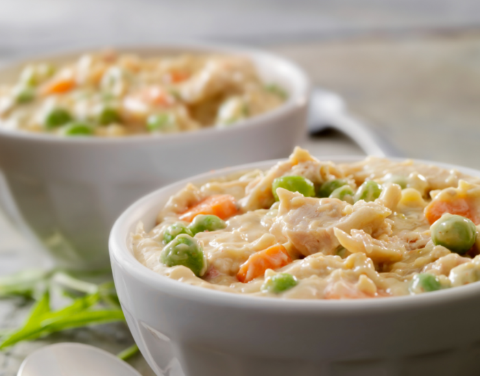 a bowl or two of chicken a la king and rice and veggies
