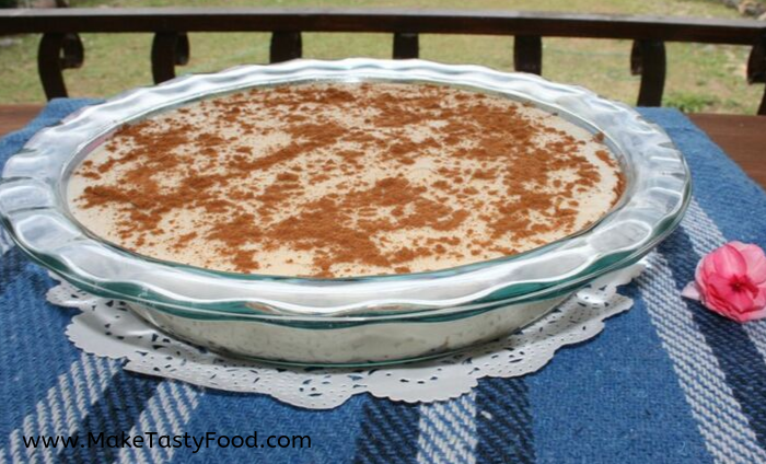 a pie dish with milk tart sprinkled with cinnamon