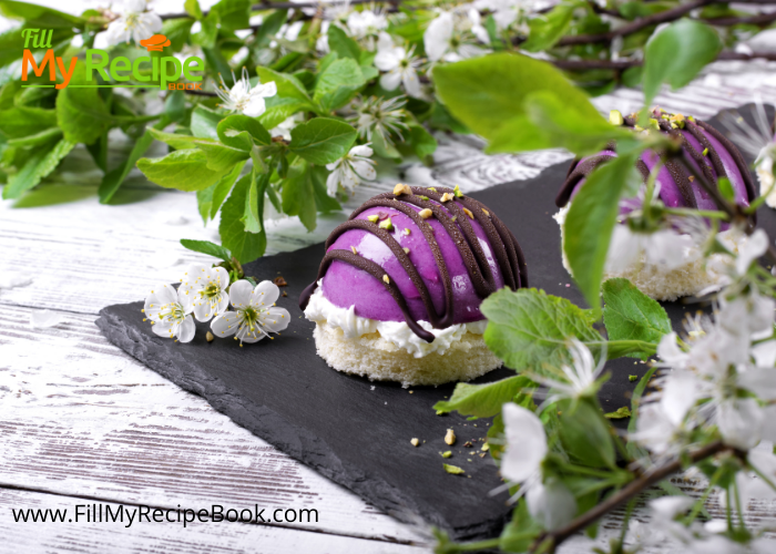 Mini Blueberry Mousse Cakes Glazed and decorated with chocolate and cream. Base is a almond sponge cake with blueberry mousse fillings.