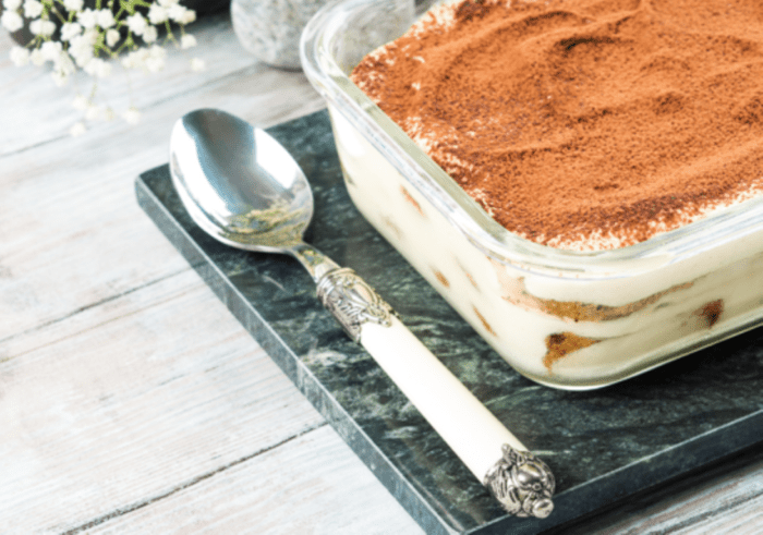 Tasty No Bake Tiramisu Tart with coffee and dusted with cocoa served for tea on mothers day
