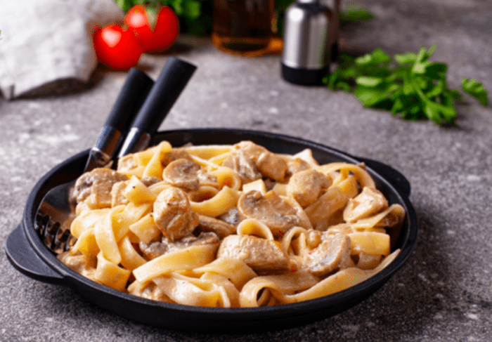 One Pot Pasta with Chicken & Mushrooms sauce. Cooked chicken added in the sautéed onion, garlic and mushrooms, with coconut milk and pasta.