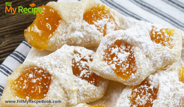 Polish Kolaczki Cookies pastry made with cream cheese and filled with apricot jam twisted and baked and dusted with icing sugar. 