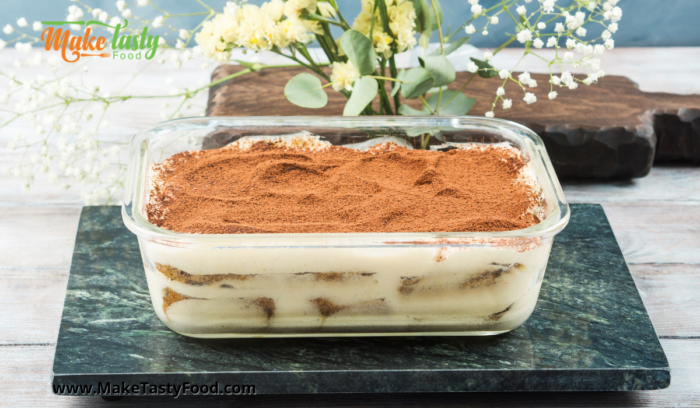 Tasty No Bake Tiramisu Tart made on stove top with coffee and lady fingers biscuits sprinkled with cocoa powder.