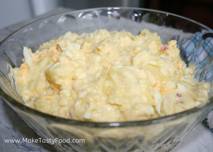 my mothers Creamy Potato Salads that is so delicious with boiled egg finely chopped red onion and mayonnaise. 