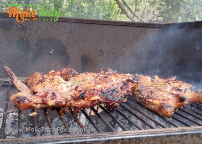 Juicy Grilled Whole Lemon Chicken on a braai for a mothers day meal. cut into pieces to serve with veggies and sides