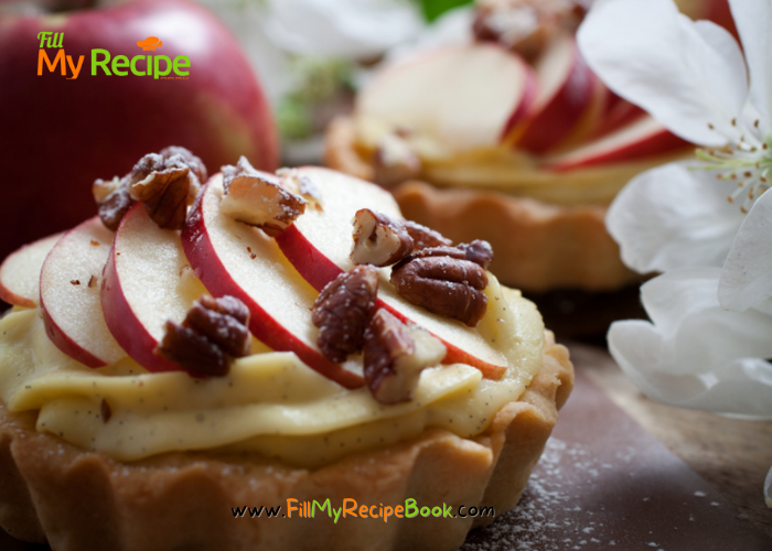 Mini Apple Cream Tartlets recipe with baked shortbread pastry for tarts. Filled with creamed apple sauce, slices of fresh apples for dessert.