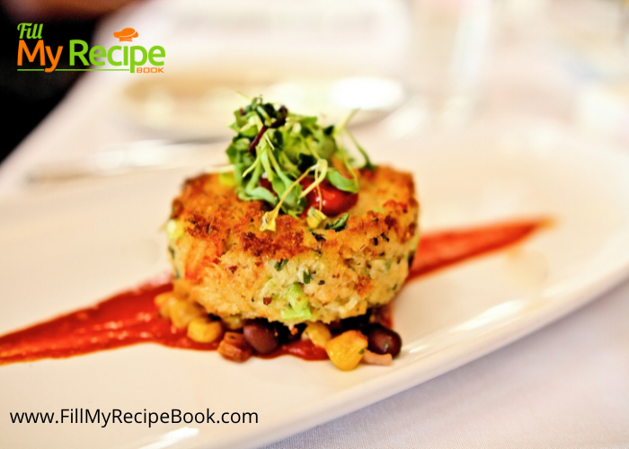 Crab Cake with Tomato Butter Sauce recipe plated for a gourmet fine dining dinner. Easy dish to serve for a meal set on corn salad.