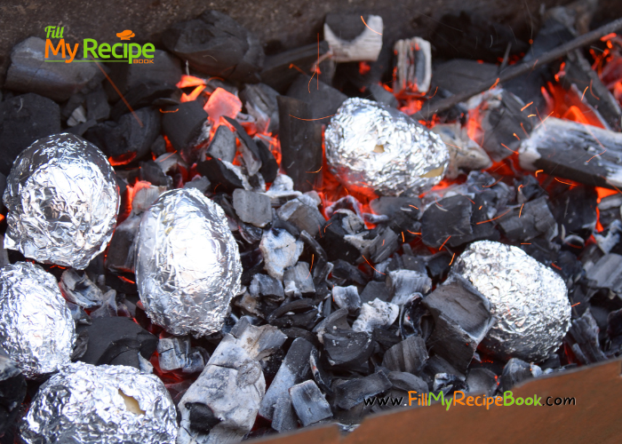 Baked Potato in Foil on Coals recipe for a braai or a barbecue on hot grill. Potato with skin on in foil baked on coals as a side dish idea.