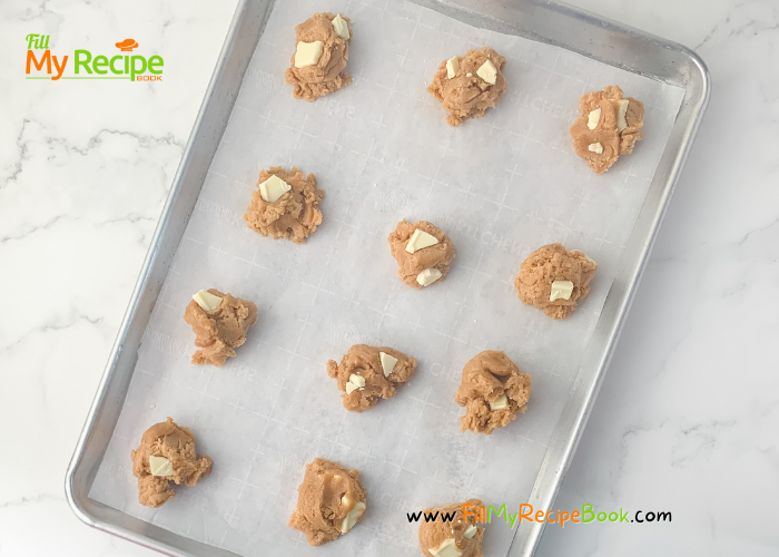 preparing to bake the cookies with the dough rolled in balls place on the line baking sheet.