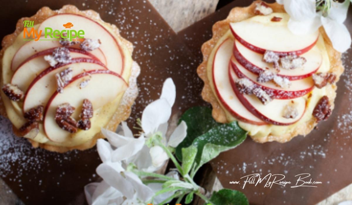 Mini Apple Cream Tartlets recipe with baked shortbread pastry for tarts. Filled with creamed apple sauce, slices of fresh apples for dessert.