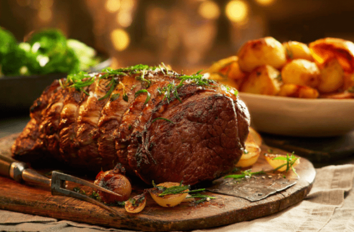 Simple Roasted Beef Recipe in the oven for dinner. Roasted beef cut with herbs and spices with onion and garlic, for meals gluten free.