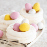 Mini Easter Pavlova Nests recipe idea for individuals. Decorated with candy easter eggs for a filling for snacks or dessert, make some ahead.