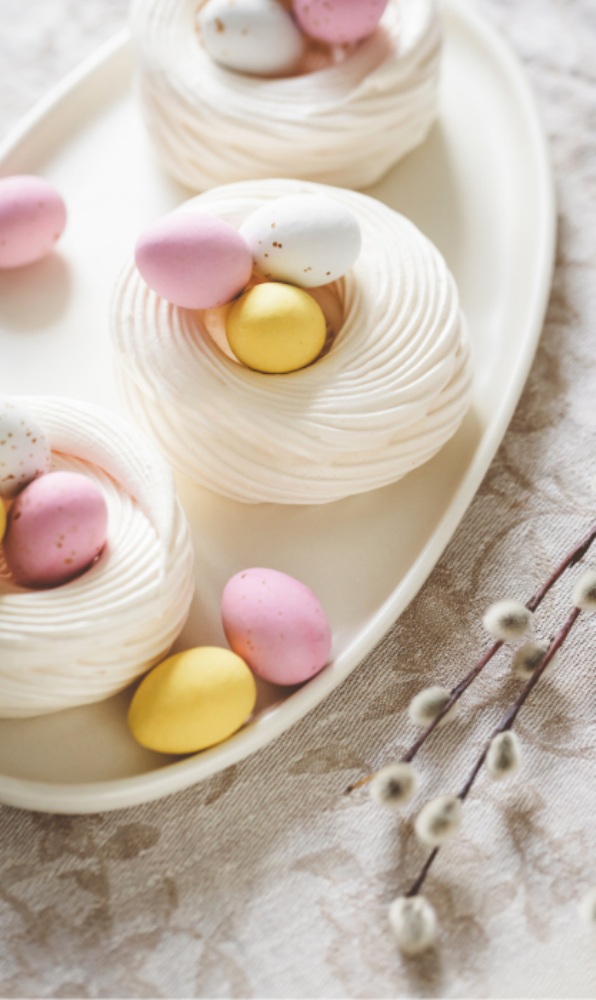 Mini Easter Pavlova Nests recipe idea for individuals. Decorated with candy easter eggs for a filling for snacks or dessert, make some ahead.