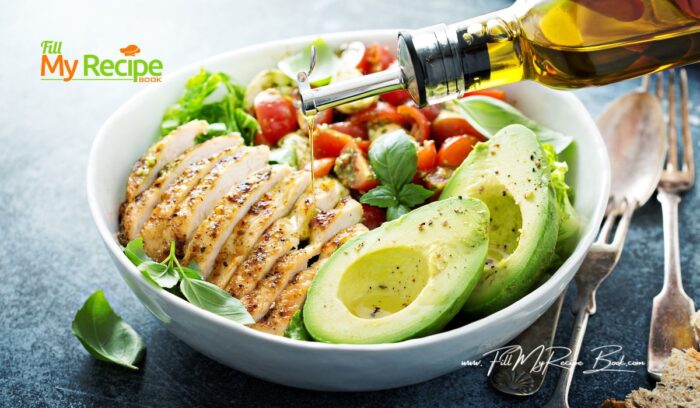 A simple Grilled Chicken Caprese Lunch Bowl with avocado recipe for summer. Served with lettuce and cherry tomatoes and cheese.