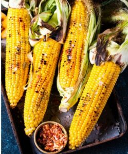 Grilled Corn on a Braai or Barbecue recipe idea for a side dish. Mielies is what the traditional South African call it eaten with butter.