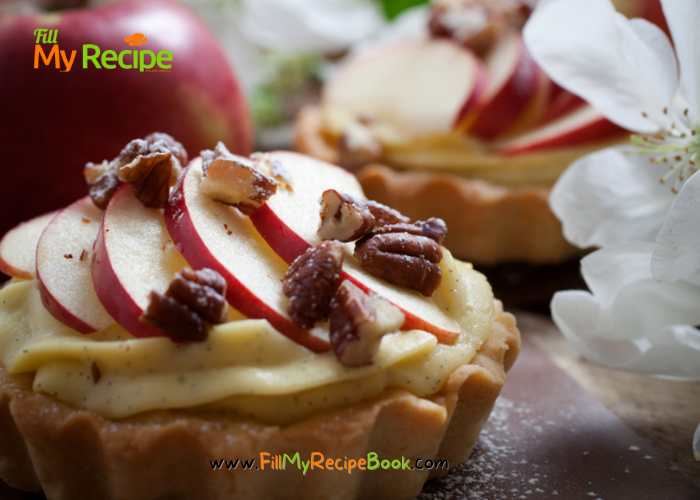 Mini Apple Cream Tartlets recipe with baked shortbread pastry for tarts. Filled with creamed apple sauce, slices of fresh apples for dessert.