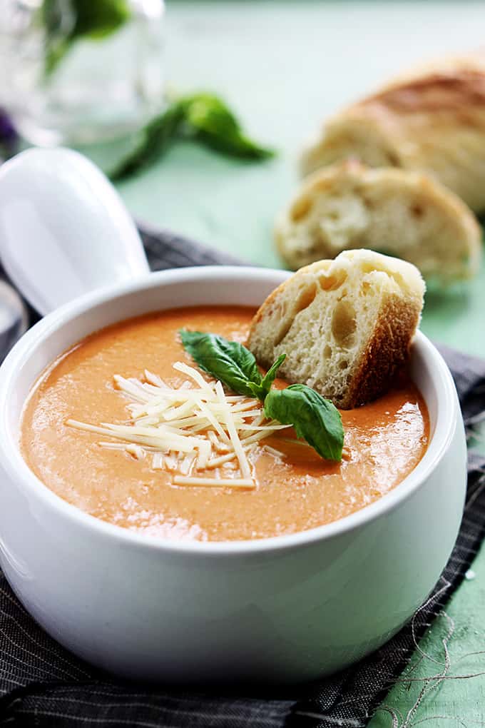 Creamy and rich tomato basil and cheesy parmesan soup made in the crockpot! Comfort food at its best!  