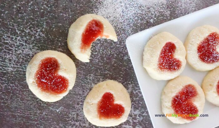 Strawberry Heart Thumbprint Cookies recipe. An easy dough mix idea and strawberry jam or puree filling for a snack at Christmas holidays.