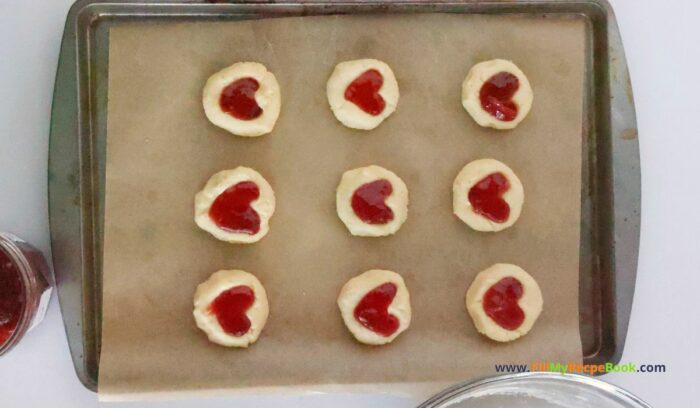 Strawberry Heart Thumbprint Cookies recipe. An easy dough mix idea and strawberry jam or puree filling for a snack at Christmas holidays.