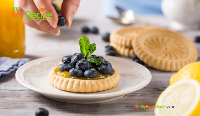 A mini Lemon Curd & Blueberry Tartlets Recipe. Oven baked dessert with shortbread crusts, filled with tangy lemon curd with blueberries.