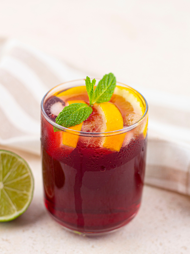 Kombucha Orange Mule Recipe idea. A healthy flavorful non alcoholic drink with a touch of lime, orange juice and slices served with mint.