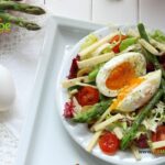 Easter Holiday Spring Breakfast Salad recipe idea. A healthy easy bowl of salad for brunch with egg and sautéed asparagus with a dressing.