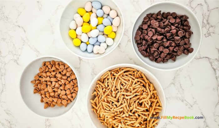 4 ingredients, Easter Nest Haystack Treats recipe for snacks. Easy enough for kids to help make, with a chocolate nest and mini candy colorful coated eggs.