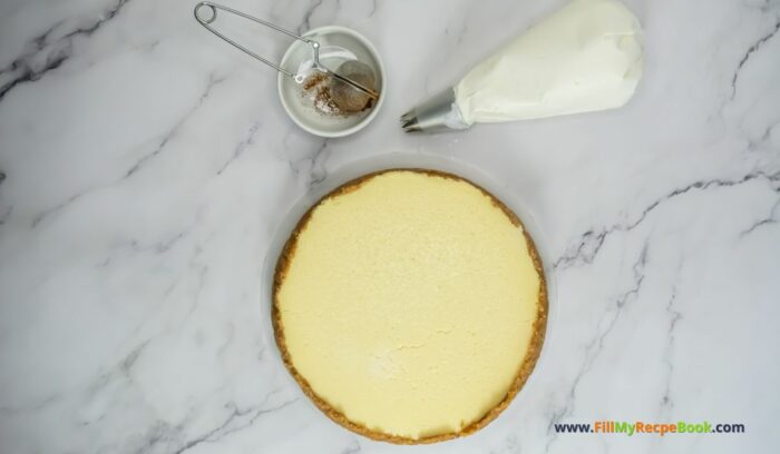 Easy Rumchata Cheesecake Recipe idea. Oven Baked with biscuit base and creamy liqueur flavor with cinnamon and cream topping for dessert.