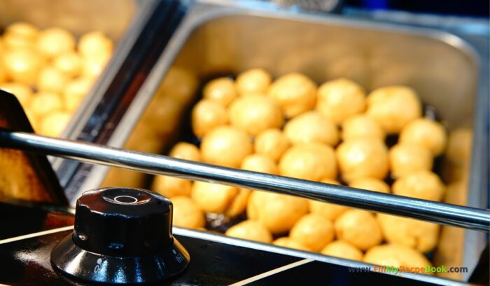 frying Salt Cod Fritters a Healthy Lunch Recipe Idea with salad. 