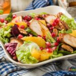 Spring Salad Chicken Pomegranate Honey recipe idea for summer or spring. Healthy side dish has orange, nuts, lettuce and a drizzle of honey.