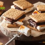 Homemade Marshmallow s'mores with Chocolate and crackers recipe idea. Melted marshmallows on the open fire while camping in spring or summer.