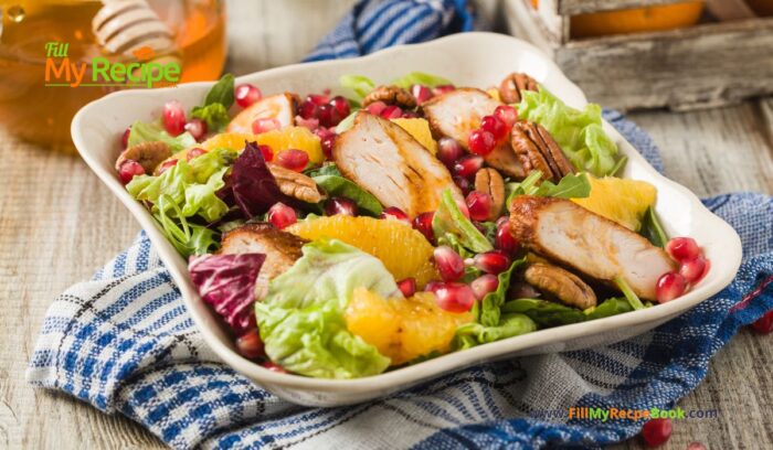 Spring Salad Chicken Pomegranate recipe idea for summer. Healthy dinner has orange, nuts, lettuce and dressing with honey.