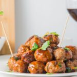 Sweet and Spicy Cocktail Meatballs recipe idea made from scratch. Mini beef appetizers oven baked with honey and barbecue sauce on a stick.