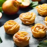 Mini Apple Rose Tarts recipe. A simple but delicious sweet apple oven baked apple pie or tart for a dessert garnished with castor sugar.