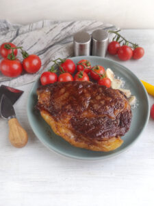 Best Grilled Ribeye Steak recipe in a cast iron pan. Easy stove top idea for dinner or lunch as the steak is grilled with butter, garlic.