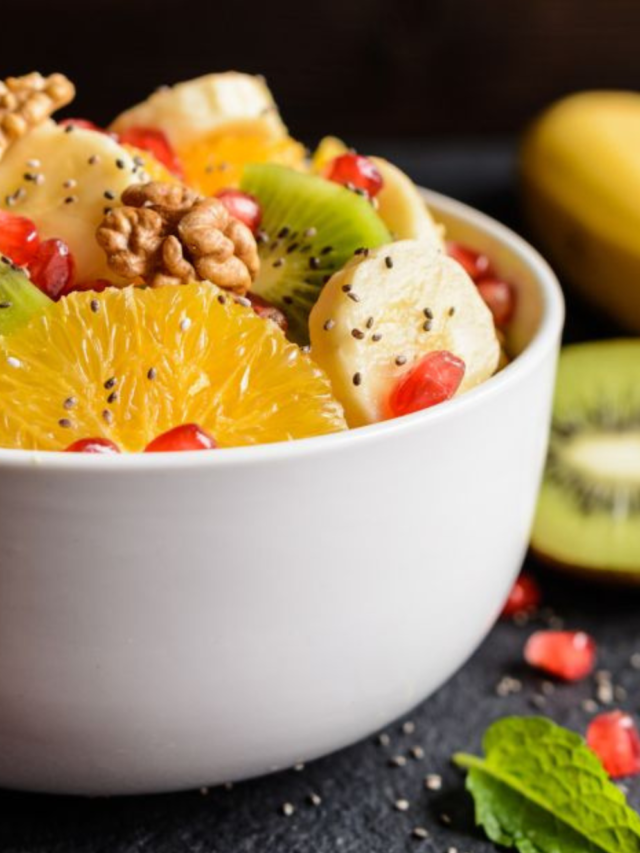 Healthy Kiwi Fruit Salad with Walnuts with pomegranate, orange pieces, banana, chia seeds. An easy recipe idea to create for a winter salad.