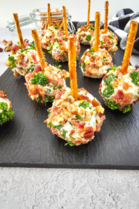 Mini Appetizer Cheeseballs Bites recipe for a No Bake party snack. Easy individual cheeseballs with bacon, pecan nuts, with a pretzel stick.
