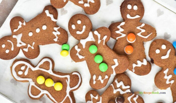 Festive and Easy Gingerbread Men Cookie Recipe Idea for a Delightful Snack. These cookies feature a soft center, crispy edges, and a spicy flavor, all beautifully decorated with a white glaze and mini M&M's.