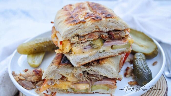 A delicious Easy Cuban Sandwich Recipe for lunch. Filled with ham, roast pork pieces, cheese, mustard, and dill pickles. Grilled in 6 minutes.
