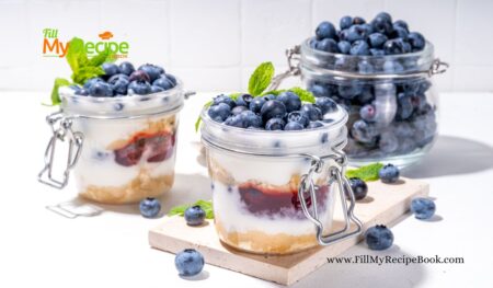 Layered Blueberry Parfait Dessert Recipe. A no-bake delight features crushed biscuits, honey infused cheesecake, and jam, all topped with fresh berries.