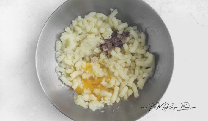 Peel the potatoes from their skins, cut into circles. Boil in salted water or steam with a sprig of thyme for 25 minutes. Peel and dice the carrots into small cubes. Place them in a bowl, add 3 tablespoons of water and cook in the microwave for 3 minutes. Dice the ham. . Mashed potato the potatoes. Add salt, pepper and egg. Stir the potato dough with a spoon.