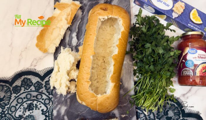 Preheat oven to 350 deg. F or 175 deg. C Prepare a pot with water for the spaghetti and a saucepan to cook the ground beef.
Hollow out the Italian bread loaf leaving the sides to hold up the filling.