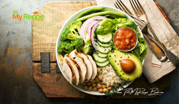 To prepare your dish add the lettuce and a little bit of basil leaves on one side. Place some cucumber and onion on the leaves, as well as the avocado. The other half of the plate add a spoon full of rice and a spoon full of drained chickpeas and slices of chicken. Then the broccoli florets.