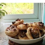 Easy Puff Pastry Raisin Roll Ups recipe idea with cream cheese. A delicious simple treat to bake in the oven with cinnamon and flaky pastry.