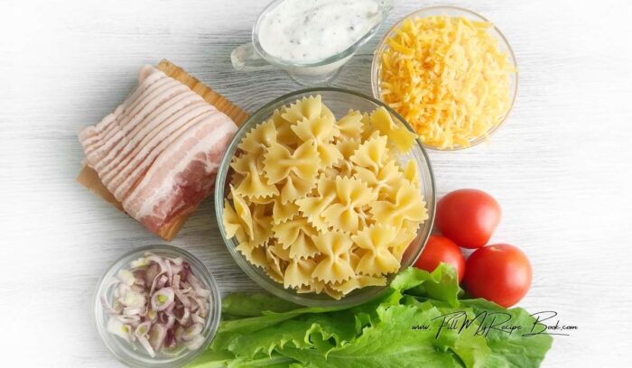 Ingredients for Tasty BLT Pasta Salad Recipe. bacon
salad greens
tomatoes
chopped purple onion
farfalle pasta
ranch dressing
shredded cheddar cheese
Salt and pepper to taste