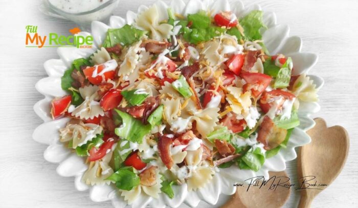 Cook the pasta according to the instructions on the package. Drain the farfalle in a colander and rinse with cold water. Place the pasta in a mixing bowl. Add the onion, tomatoes, lettuce leaves, and cheddar cheese. Toss the salad and chill for an hour. Add the dressing, salt, and pepper before serving.