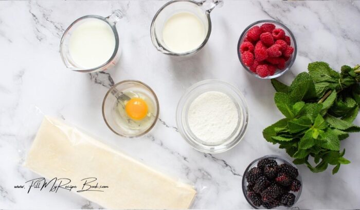 Ingredients for vanilla cream puff pastry.
puff pastry
egg, beaten
instant vanilla pudding mix
milk and heavy cream
Fresh berries (raspberries, blackberries, etc.)
Whipped cream
Fresh mint leaves