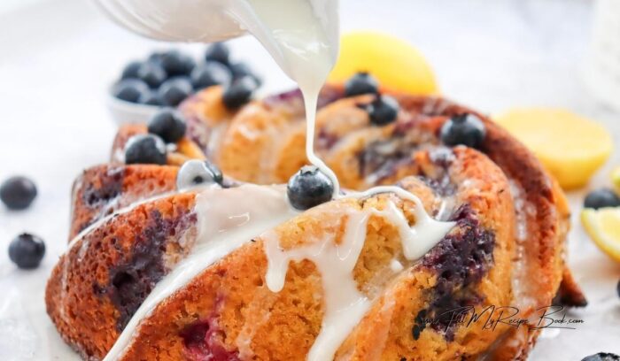 Once the cake is completely cooled, drizzle the lemon glaze over the top. Garnish with extra lemon zest if desired.