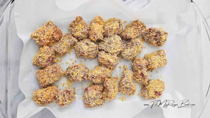 Combine Pork Panko, Parmesan cheese and salt in one bowl. For an alternative breading or batter see the notes in the recipe attached.

Beat 1 egg in another bowl.

Dip chunks or cubed tender pieces of steak into the egg, then the breading. Place on a wax or parchment lined baking sheet or pan, and freeze for 30 minutes. This will set the breading coating and prevent it from falling off when frying.
Heat oil to 162 deg. C (325 deg. F) then fry steak nuggets until browned, about 2-3 minutes. For alternative method to see if oils are ready to fry in. (see the recipe attached) 