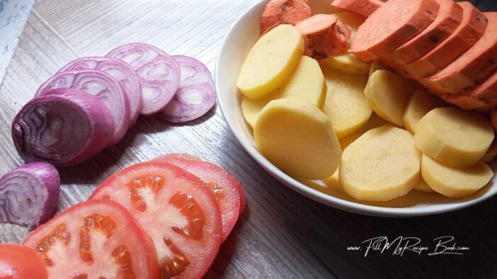 Peel you potatoes, and slice them to about 1/2 cm thick. Also slice your red onion and the tomato in slices. Similar sizes. This dish will be good for about 3-4 servings a person.